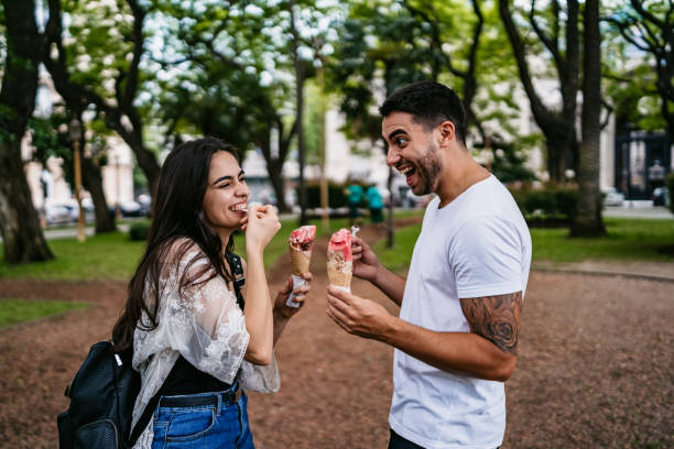 istock Happy couple sharing ice cream 1204586752