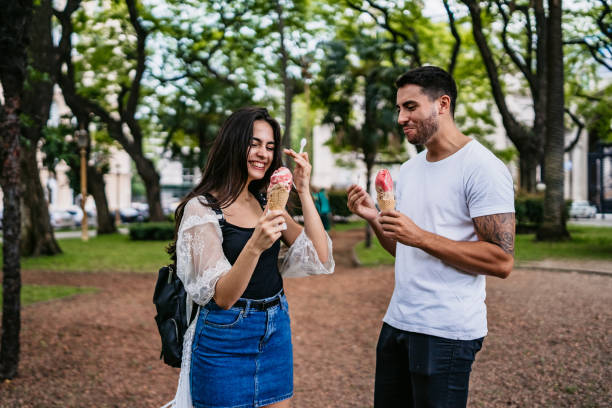 istock Happy couple sharing ice cream 1204586772