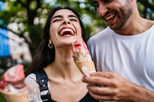 Happy couple sharing ice cream