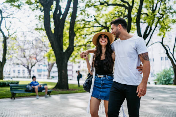 istock Young couple walking in park 1204587016