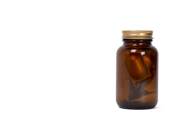 istock Brown Glass Pill Bottle On White Background 1204587267