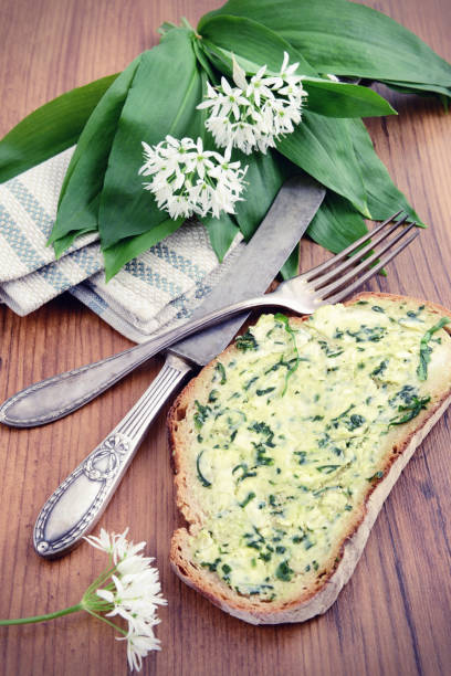 istock fresh bread with ramson wild garlic leaves and butter. antique silverware 1204588123