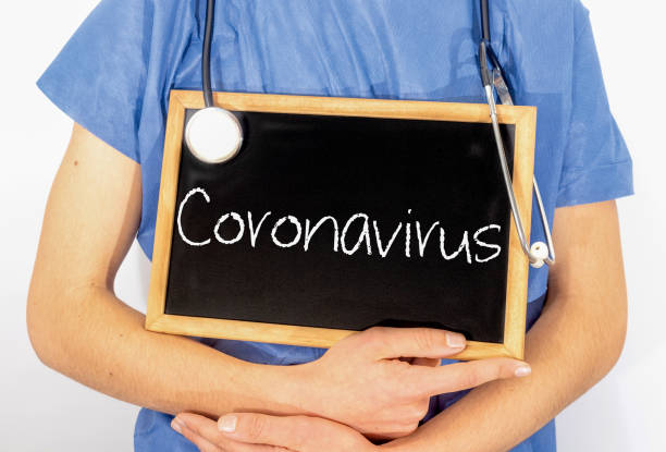istock Doctor shows information on blackboard: coronavirus.  Medical concept. 1204588142