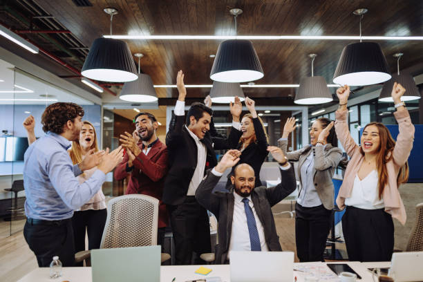 istock Latin business team celebrating successful investment 1204589904