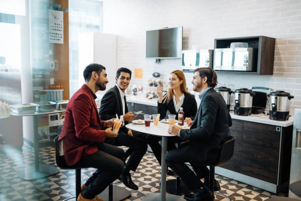 istock Latino employees taking a break at work, eating snack and chatting. 1204590161