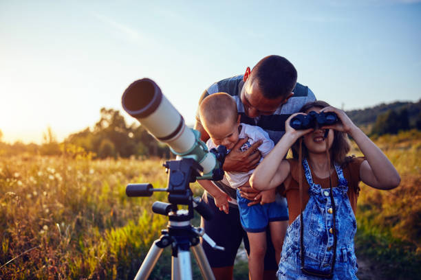 istock Father, daughter and son observing the sky with a telescope. 1204591831