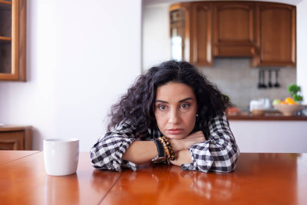istock Young woman drinking coffee at home 1204592087