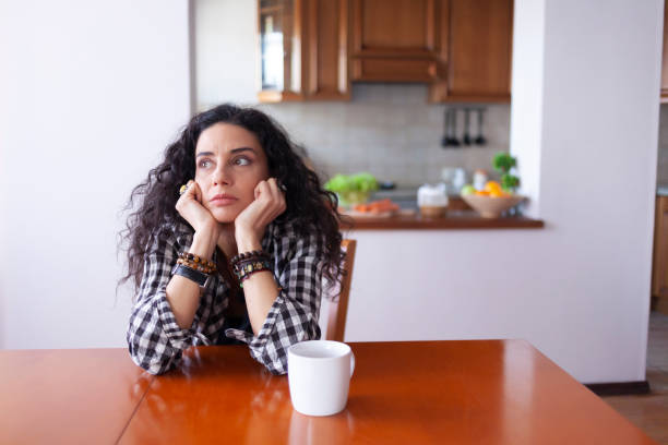 istock Young woman drinking coffee at home 1204592092