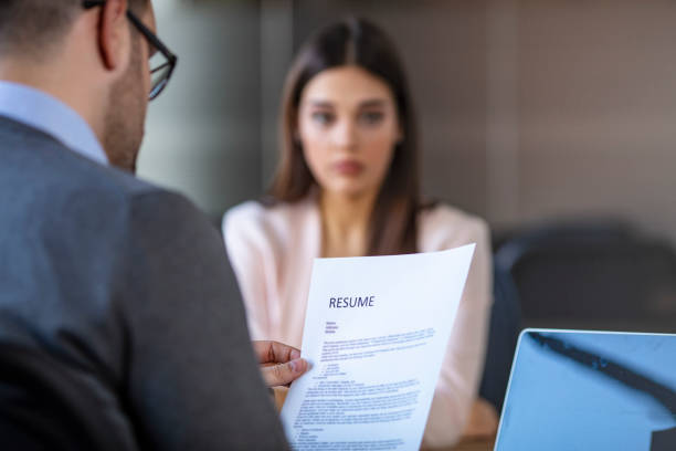 istock Job interview in office, focus on resume, close up. 1204592271