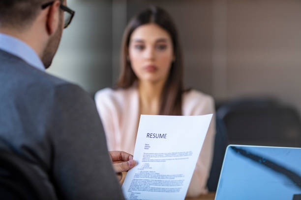 istock Job interview in office, focus on resume, close up. 1204593009