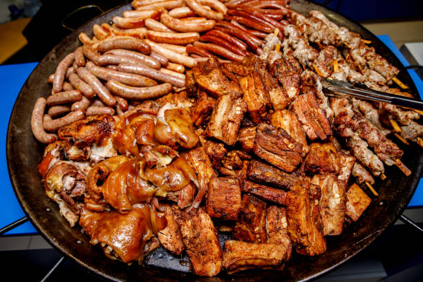 istock Assorted meat. Grilled sausages, ribs, shank in a large skillet 1204594445