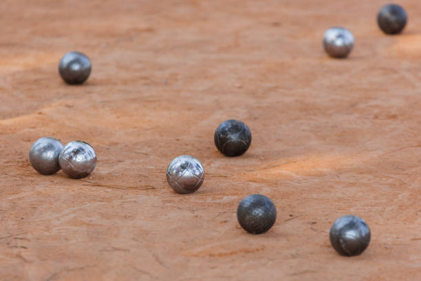 Pétanque Boules Game being played by three boys in the desert at sunrise Namib Rand Namibia Africa