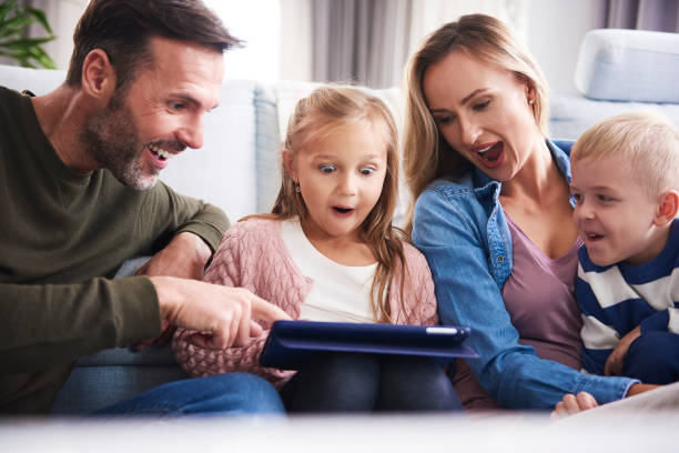 istock Surprised parents with children looking at tablet 1204595173