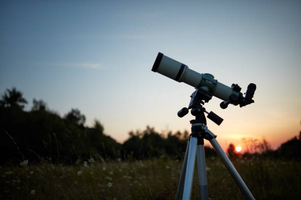 istock Telescope for observing the universe on a meadow outdoors. 1204596533