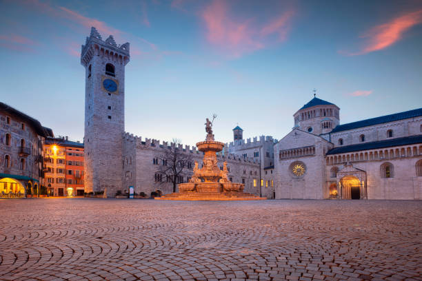 Trento, Trentino, Italy. Cityscape image of Duomo Square with Trento Cathedral and the Fountain of Neptune located in historical city of Trento, Trentino, Italy during twilight blue hour. blue hour twilight photos stock pictures, royalty-free photos & images