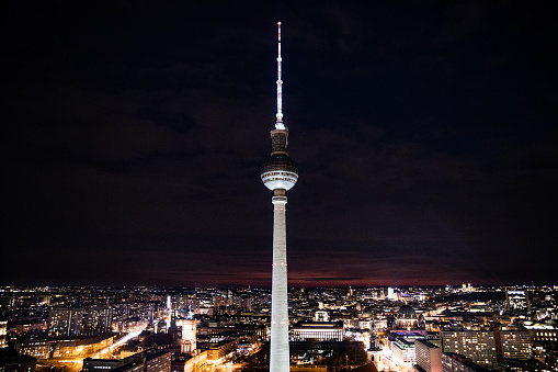 TV tower in Berlin at night with clouds.