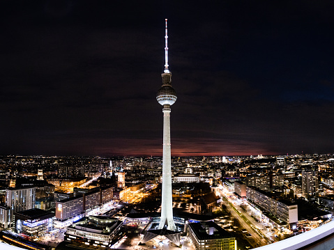 TV tower in Berlin at night with clouds.