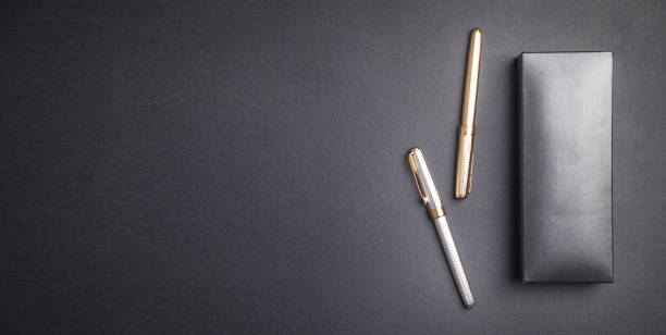 istock Pens and box on the black background. 1204600487