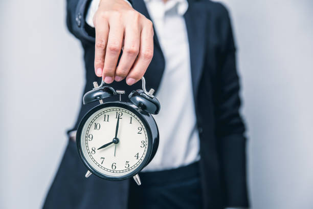 istock business people with clock times showing for warning time delay urgent or hurry up working concept 1204601425