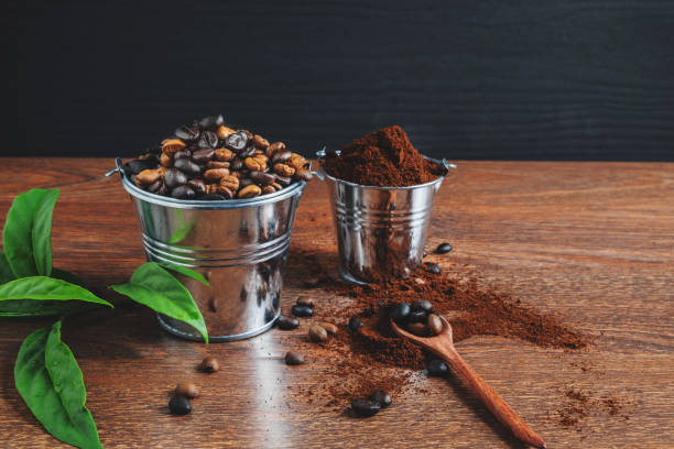istock Roasted coffee beans and coffee powder on a wooden table 1204601594