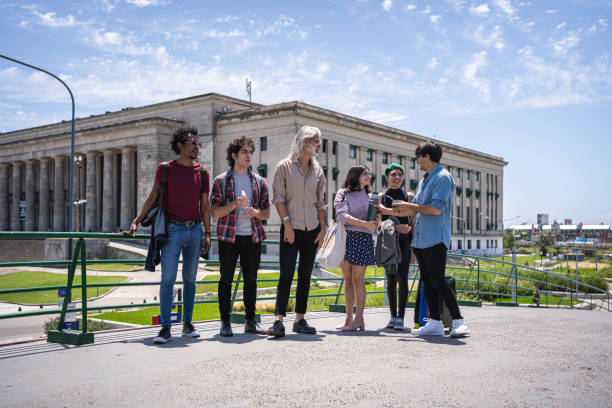istock Group of students standing in front of a university building 1204601693