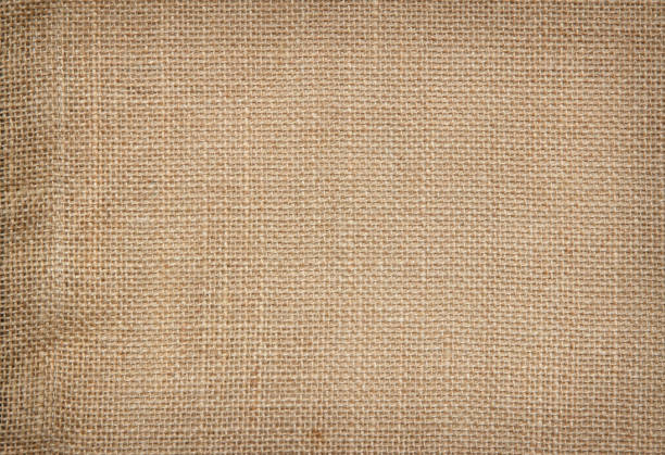 istock Brown Hemp rope texture background. Sackcloth or blanket wale linen wallpaper. Rustic sack canvas fabric texture in natural. Haircloth vintage linen burlap weaving, Old beige carpet background. 1204601923