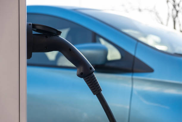 istock Electric Car is charging in the downtown parking lot 1204602796