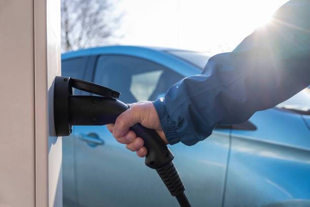 istock Electric Car is charging in the downtown parking lot 1204602820