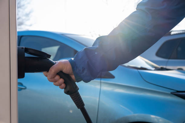 istock Electric Car is charging in the downtown parking lot 1204602832