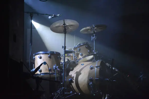 Drumset on a stage with one lightsource