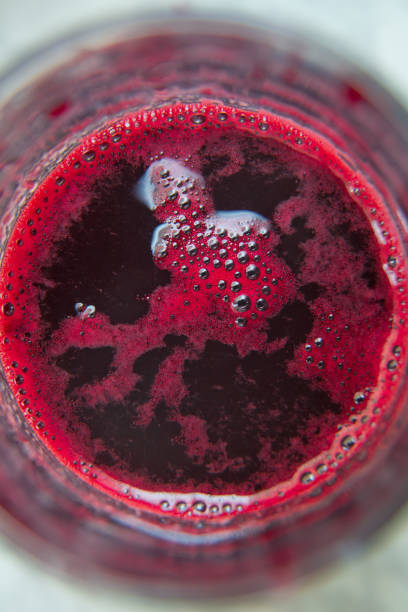 Glass of beet juice isolated on white . Fresh juice just made from beetroot a glass shot from bird-eye-perspective isolated on white background