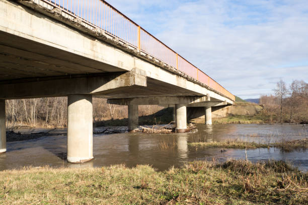 istock Reinforced concrete bridge over a small river. Autumn landscape. 1204605294