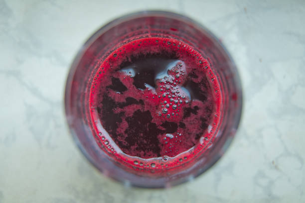 istock Fresh juice just made from beetroot a glass shot from bird-eye-perspective isolated on white background . Glass of beet juice isolated on white . 1204607004