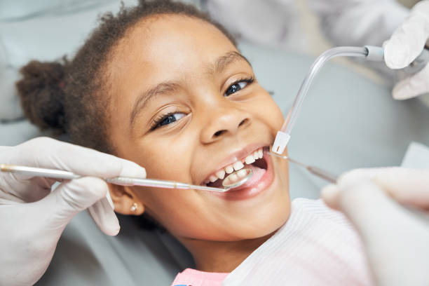 Cute african girl during dental treatment at modern clinic stock photo