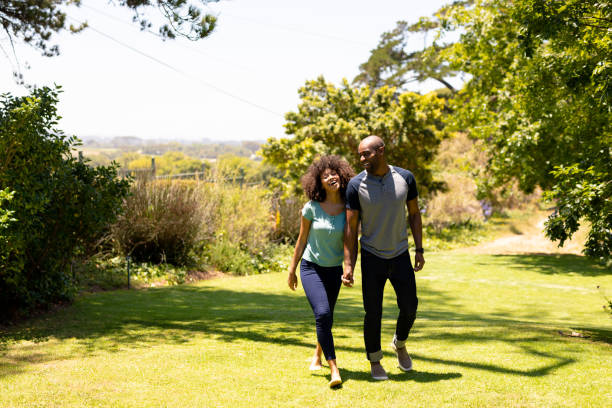 istock Happy young couple walking in the garden 1204610704
