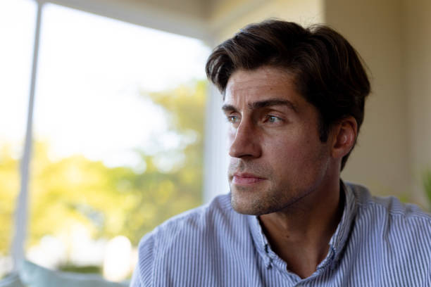 istock Young man at home looking away 1204610936