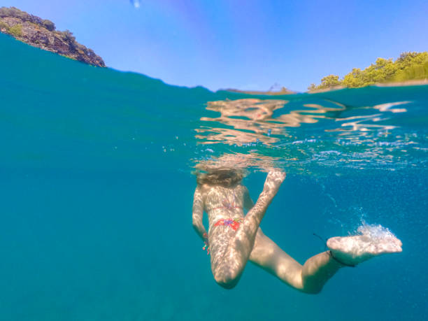 istock Woman floating in the clean sea. 1204612011