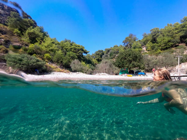 istock Woman floating in the clean sea. 1204612244