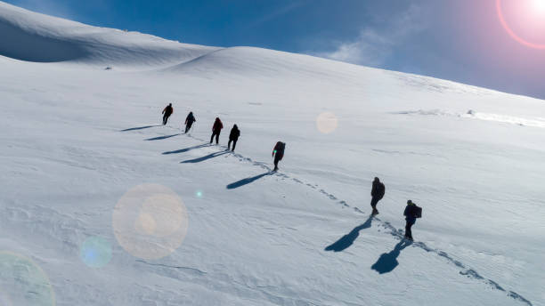 istock mountaineer group and high mountains heading towards the destination 1204613920