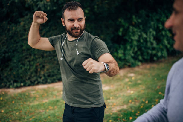 istock Son and father jogging in a public park 1204614003