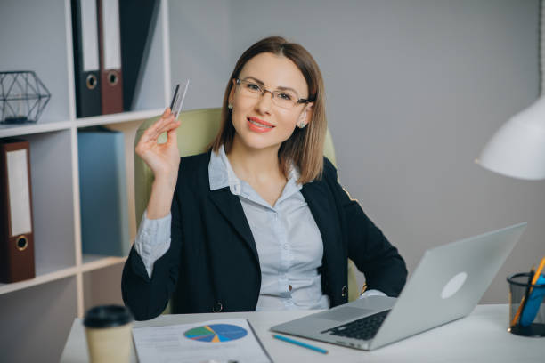 istock Confident Young Businesswoman Working With Data From Financial Documents at Her Workplace in Modern Office. Portait of Pensive Business Lady Office Worker at Workplace 1204617448