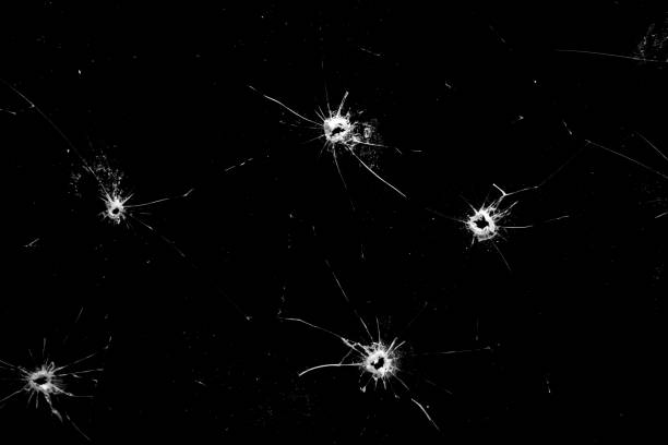 istock holes in the glass with cracks isolated on a black 1204618276
