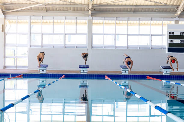 istock Swimmers plunging in the pool 1204618627