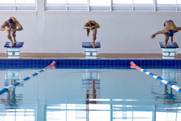 istock Swimmers plunging in the pool 1204618706