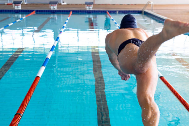 istock Swimmer plunging in the pool 1204618873