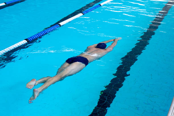 istock Swimmers swimming in the pool 1204619100