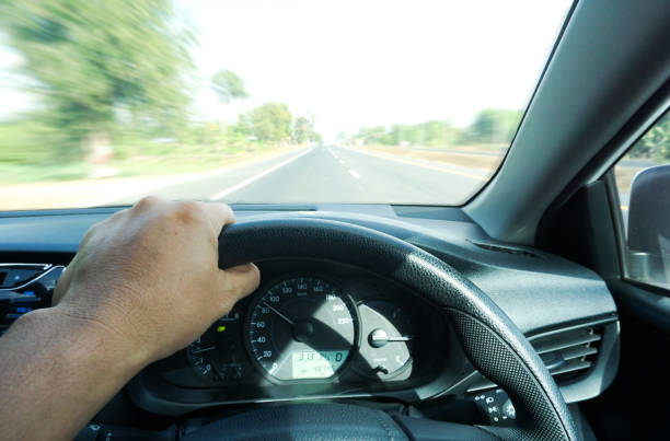 istock man driving car from rear view on the highway. 1204619154