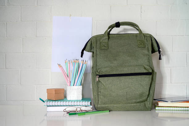 istock back to school concept with backpack and supplise on white table. 1204620070