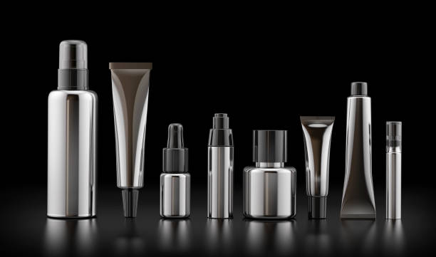 istock Cosmetics metallic bottle and tube on black glossy background 1204620669