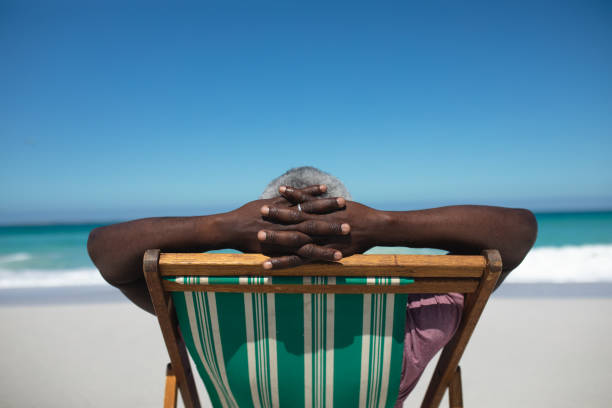 istock Old man relaxing at the beach 1204620723